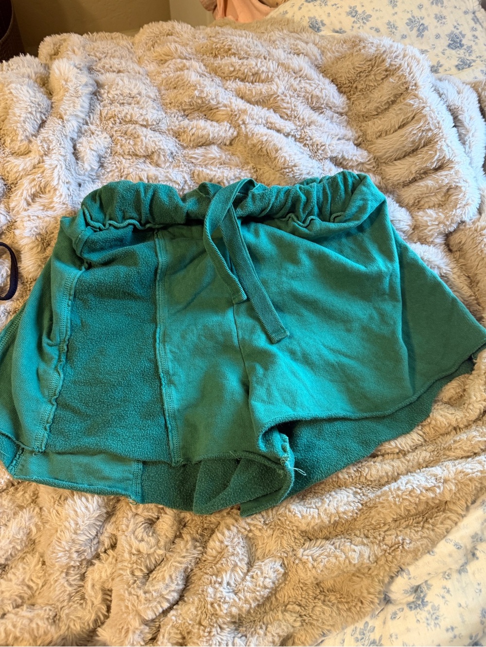 Out from under green shorts